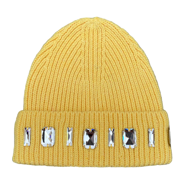 Yellow beanie with decorative gems on a textured surface